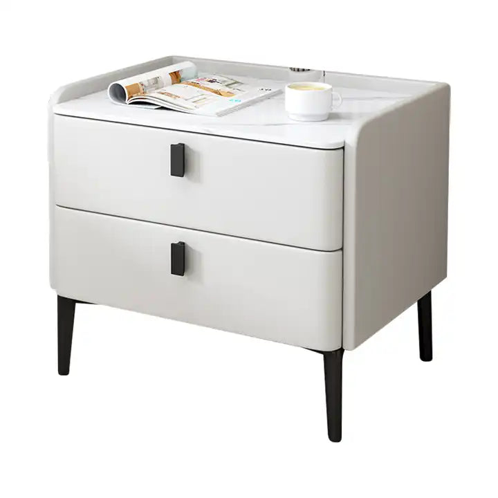 a white nightstand with a magazine on top of it